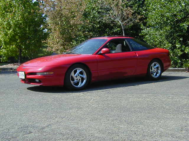 Red 1997 Ford Probe GT coupe with aftermarket wheels