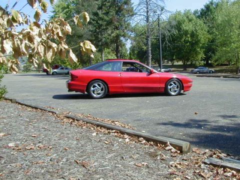 1997 Ford Probe - A red 1997 Ford Probe GT is parked in a lot on a sunny day.