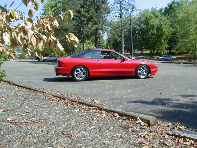 Red 1997 Ford Probe GT coupe, side view
