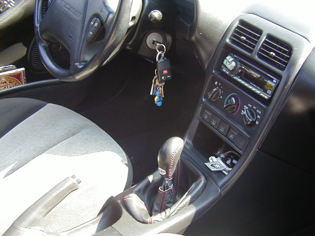 1997 Ford Probe interior with cloth seats, automatic shifter, and aftermarket stereo
