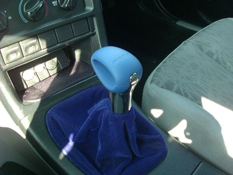 1995 Ford Probe - Interior shot of a car's center console, focusing on the shifter area with custom blue accessories.