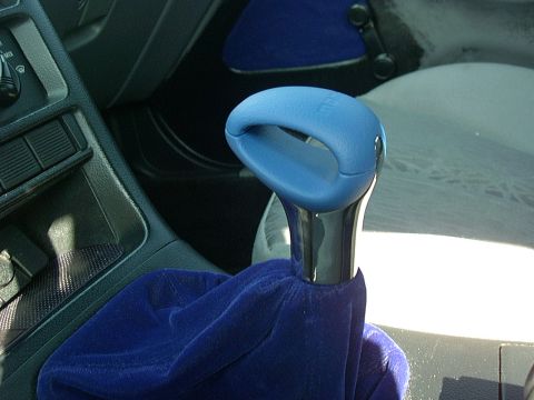 1995 Ford Probe - The interior of a car features a blue shifter knob and a matching blue velvet shifter boot.