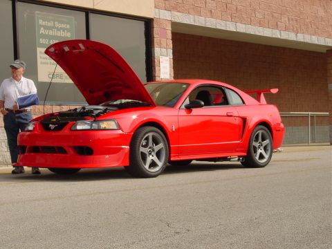 1986 Ford Mustang - Red 2000 Ford Mustang Cobra parked with hood open, a man standing next to it.