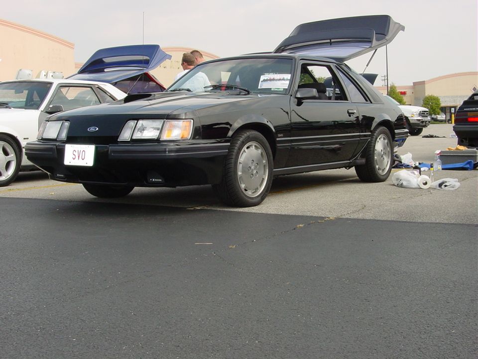 Black 1986 Ford Mustang SVO coupe with hood scoop, 3q-front view