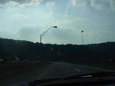 1986 Ford Mustang - Driving on a highway with streetlights visible against a cloudy sky.