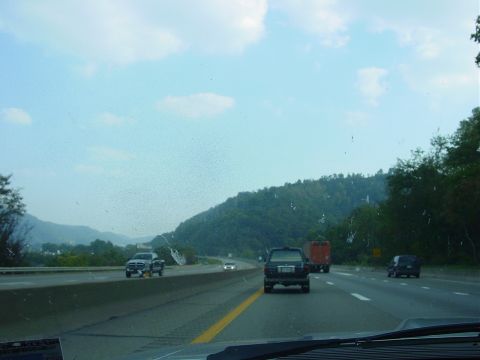 1986 Ford Mustang - A view from a car driving on a highway with other vehicles on the road.