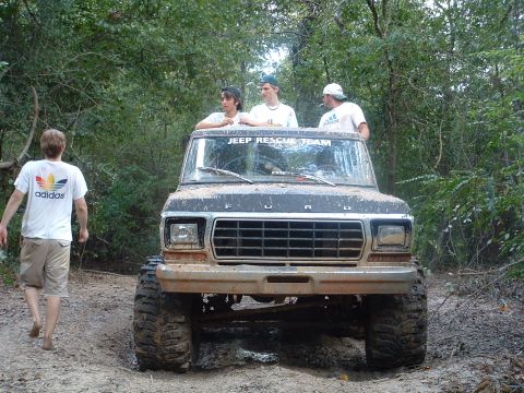 1993 Ford Bronco - A group of friends are out off-roading in a lifted Ford truck.