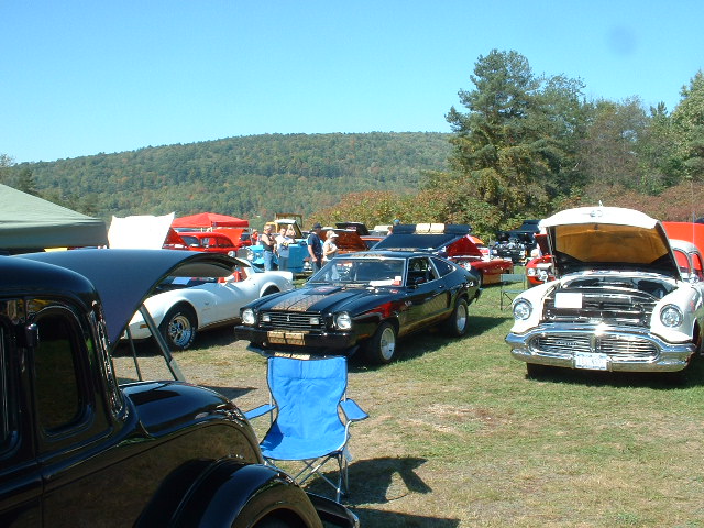 1978 Ford Mustang II and other classic cars on display at an outdoor event