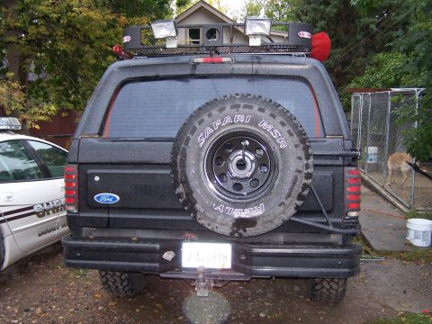 1996 Ford Bronco - Rear view of a 1996 Ford Bronco equipped with a roof rack and spare tire.