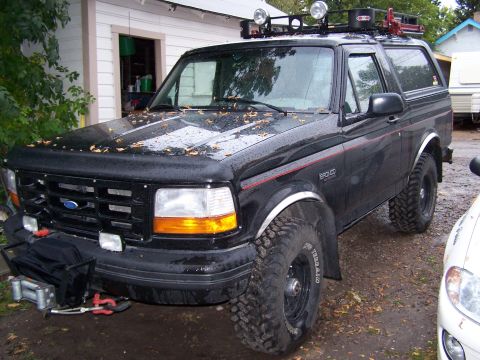 1996 Ford Bronco - This 1996 Ford Bronco features a winch on the front bumper and a roof rack with auxiliary lights.
