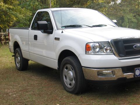 2004 Ford F-150 - White Ford F-150 pickup truck from the front 3/4 angle, parked outdoors on a grassy area.