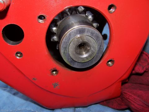 1979 Ford F-150 - A detailed view of a gear assembly, likely part of a transmission or engine component, set against a red casing.