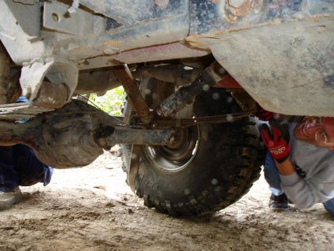 1992 Ford Bronco - A close-up view of a vehicle's undercarriage, showing suspension components and a differential.