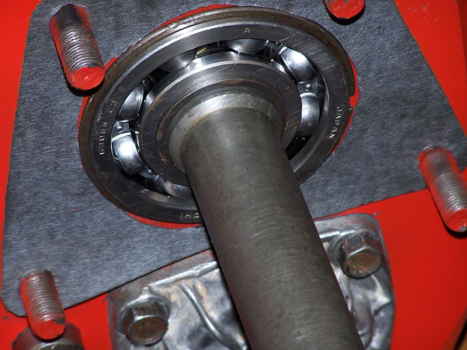 Close-up of a ball bearing assembly with a metal shaft passing through it. Text on the bearing reads "JAPAN" and "6308N"