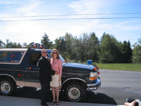 1992 Ford Bronco - A couple poses in front of a dark green 1992 Ford Bronco, possibly on their wedding day.