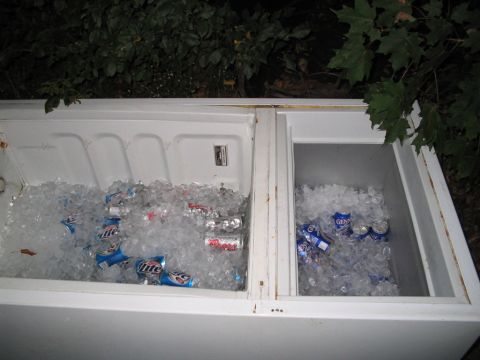 1992 Ford Bronco - A cooler filled with ice and various beer cans, likely for an outdoor gathering.