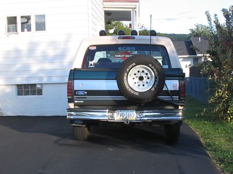 1992 Ford Bronco - The rear of a 1992 Ford Bronco is shown, a spare tire mounted on the tailgate and a license plate reading FV G-1663.