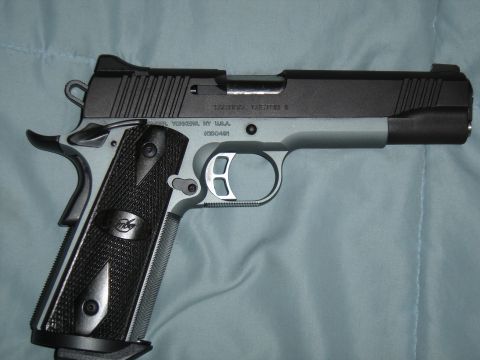1988 Ford Bronco - A two-tone handgun is shown against a blue cloth background.