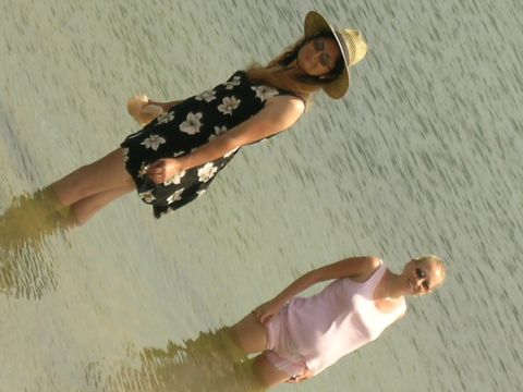 1993 Ford Probe - Two women enjoy a day in the water, with one wearing a floral dress and a straw hat.