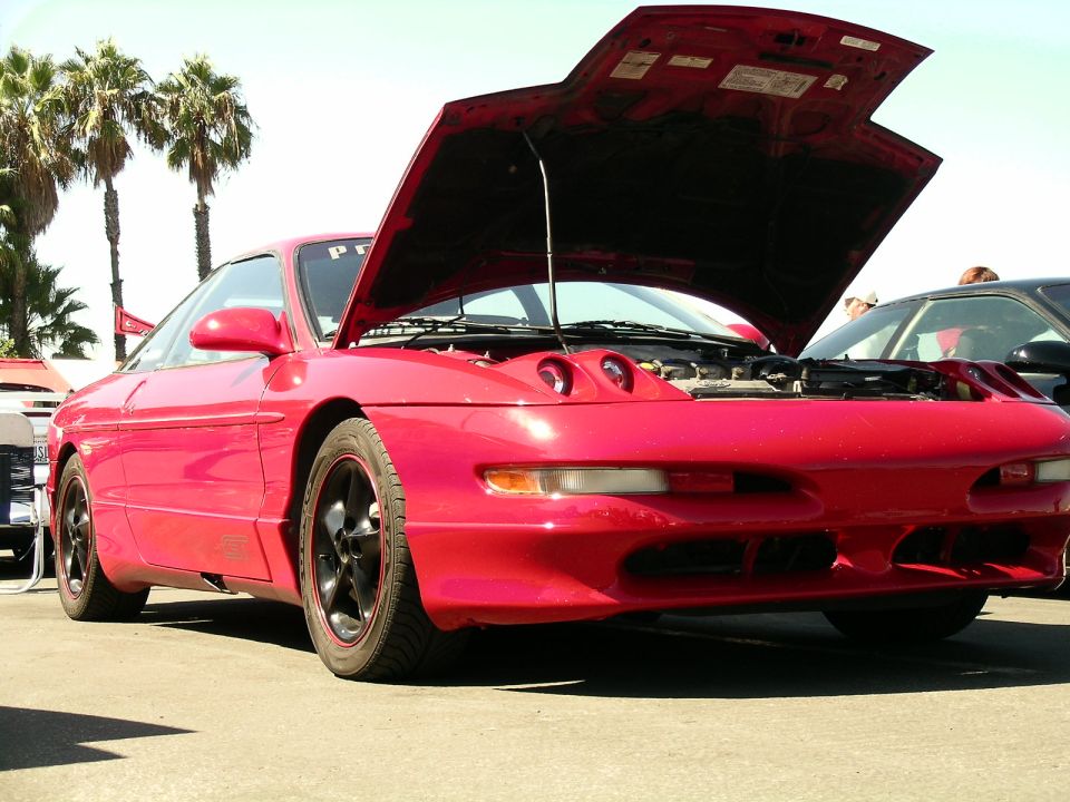 Red 1993 Ford Probe with hood open, parked outdoors. Another car is visible to the right