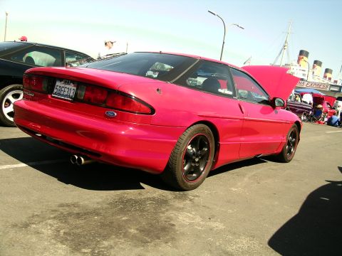 1993 Ford Probe - Red 1993 Ford Probe at an outdoor event with its hood open, parked next to another vehicle.