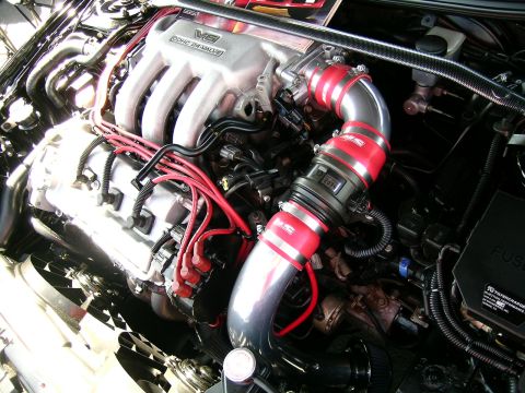 1993 Ford Probe - Close-up of a V6 DOHC 24-VALVE engine with custom red intake piping and wiring.