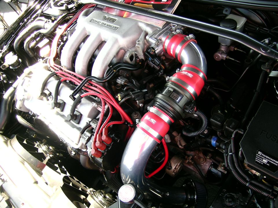 Engine bay showing V6 DOHC 24-VALVE engine with red intake piping and wiring