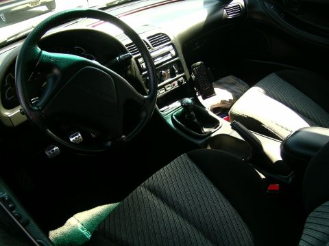 1993 Ford Probe - The interior of the car is visible, including the dashboard, steering wheel, and seats.