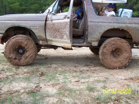 1987 Ford Bronco - Mud-covered 1987 Ford Bronco with occupants enjoying an off-road adventure on October 2, 2005.