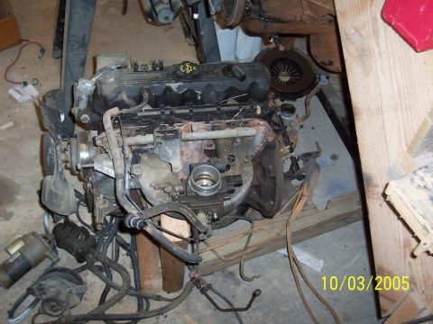 1994 Jeep YJ - Engine assembly with fan and wiring harness, likely removed from a vehicle.