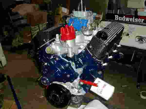 Blue engine with red distributor cap and Budweiser logo in background