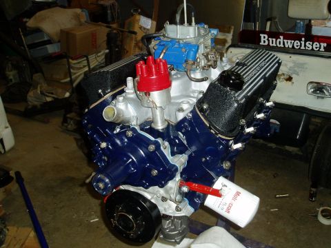1969 Ford Bronco - A Ford V8 engine is shown with a blue painted block and red distributor cap, with "Powered by Ford" valve covers visible.