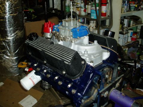 1969 Ford Bronco - A Ford V8 engine is shown with custom blue paint on the block and "POWERED BY FORD" valve covers. A Motorcraft oil filter is attached.