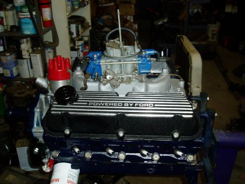 1969 Ford Bronco - A Ford V8 engine is shown with "POWERED BY FORD" valve covers and a red distributor cap.