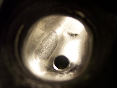 1967 Ford Mustang - View inside an engine cylinder head, showing the combustion chamber and valve seat.