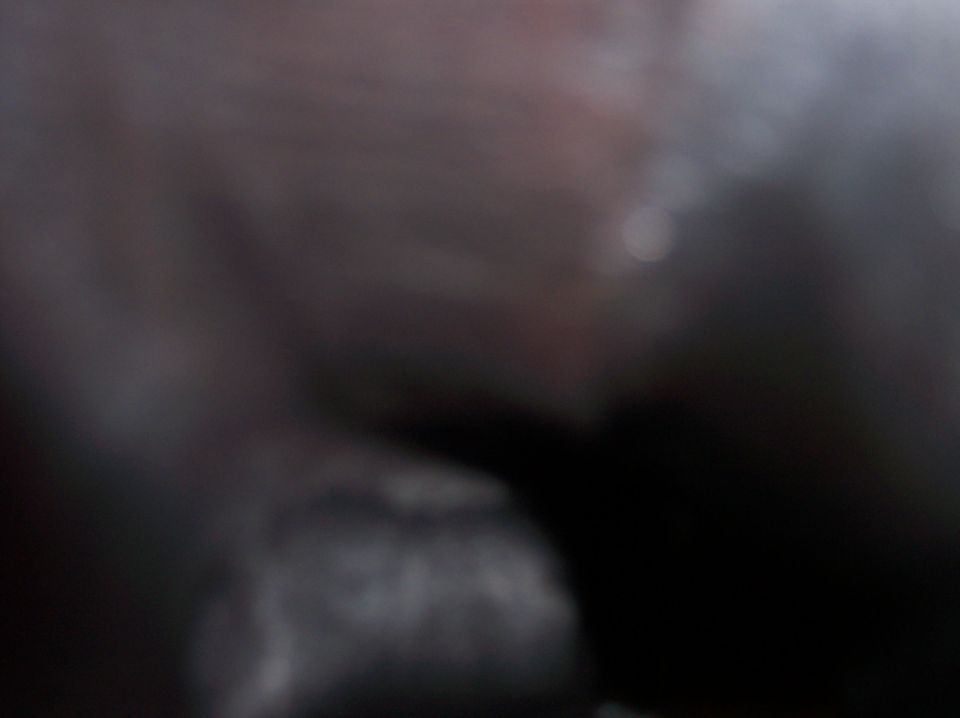 blurry dark interior of a vehicle, possibly dashboard area