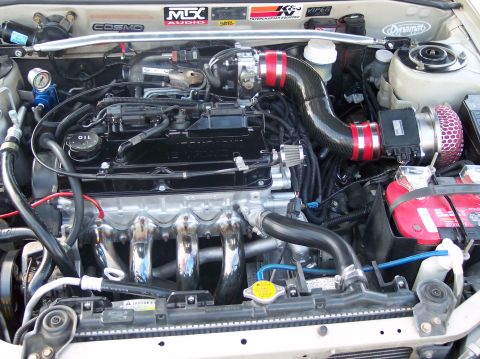1999 Mitsubishi Mirage - Engine bay modifications including an aftermarket intake and exhaust manifold are visible.