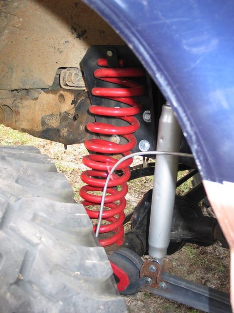 1995 Ford Bronco - Vehicle suspension components, including a red coil spring and shock absorber, are shown in detail.