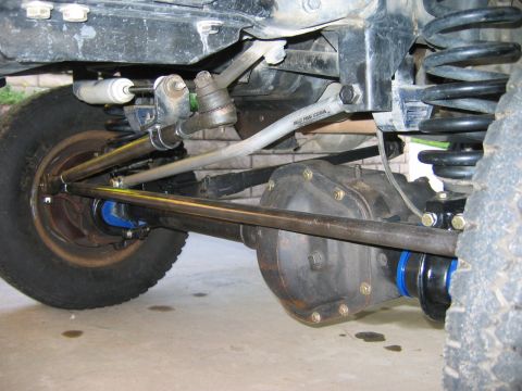 1985 Ford Bronco - Custom suspension and steering components are visible on this off-road vehicle's front axle.