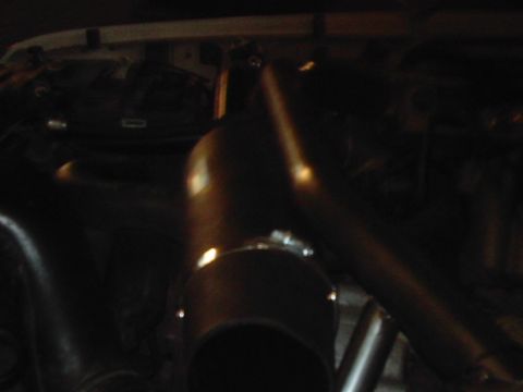 1978 Ford Bronco - Engine bay detail showing a large intake pipe and other components.