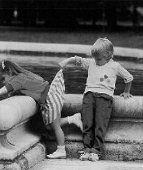 1972 Ford Ranchero - Children play near a stone fountain in a black and white photograph.