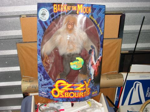 1991 Ford Bronco - A collectible Ozzy Osbourne doll is stored among various boxes in what appears to be a storage unit.