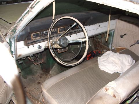 1966 Ford Ranchero - The interior of a 1966 Ford Ranchero shows its beige seats, dashboard, and steering wheel.