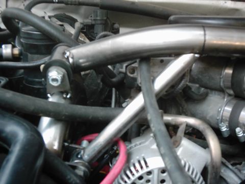 1978 Ford Bronco - Engine bay components including hoses, pipes, and alternator. Supermotors.net logo is present.