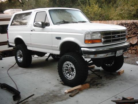 1978 Ford Bronco - This lifted white Ford Bronco sits on chrome wheels and large off-road tires.