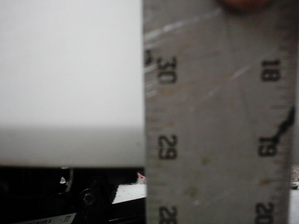 Metal ruler with inch markings showing measurements around 29-30 inches