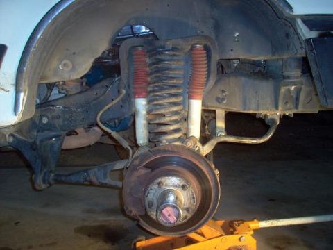 1988 Ford Bronco - Close-up of the front suspension system on a 1988 Ford Bronco, highlighting the coil spring and shock absorber.