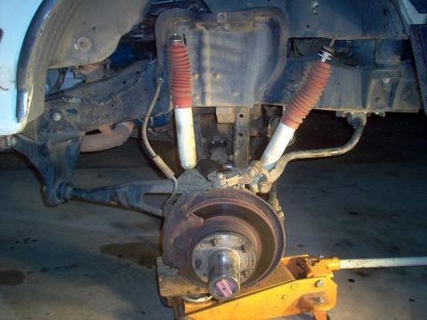 1988 Ford Bronco - Close-up of a vehicle's front suspension system, showing the shock absorbers and brake components.