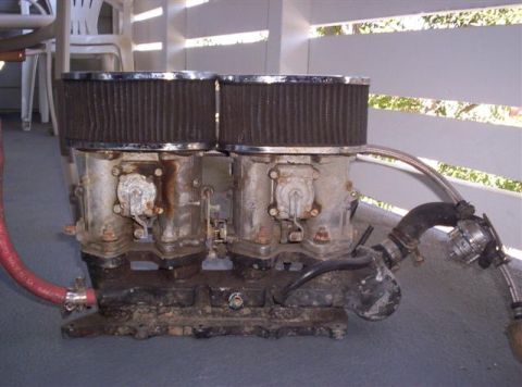 1987 Suzuki Samurai - Dual carburetors with air filters and associated plumbing are shown, not a complete vehicle.