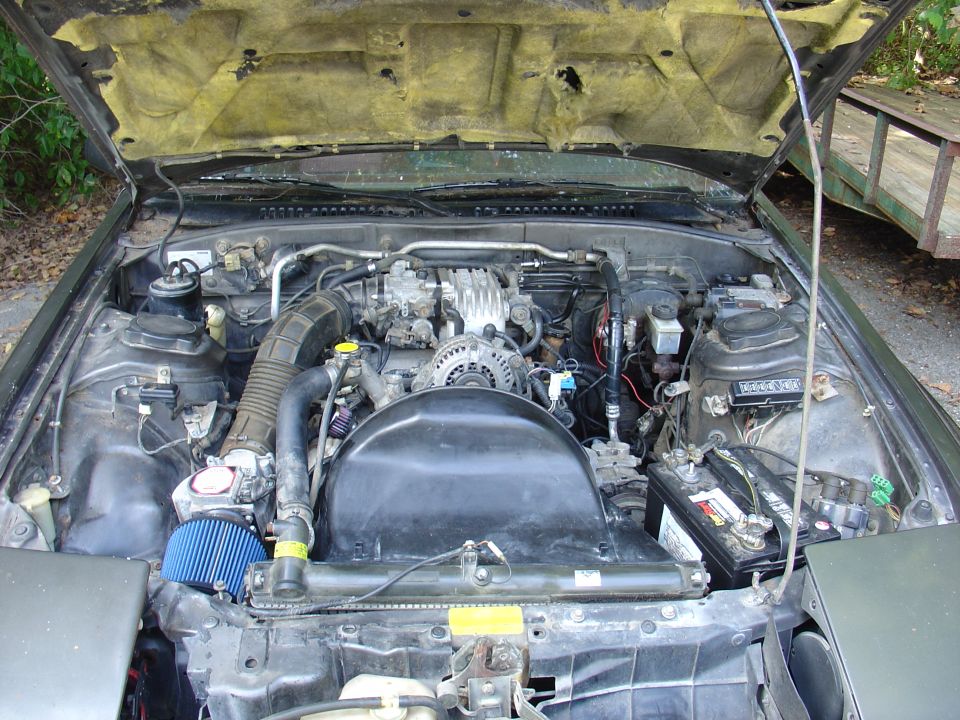 1986 Mazda RX-7 engine bay with aftermarket air filter